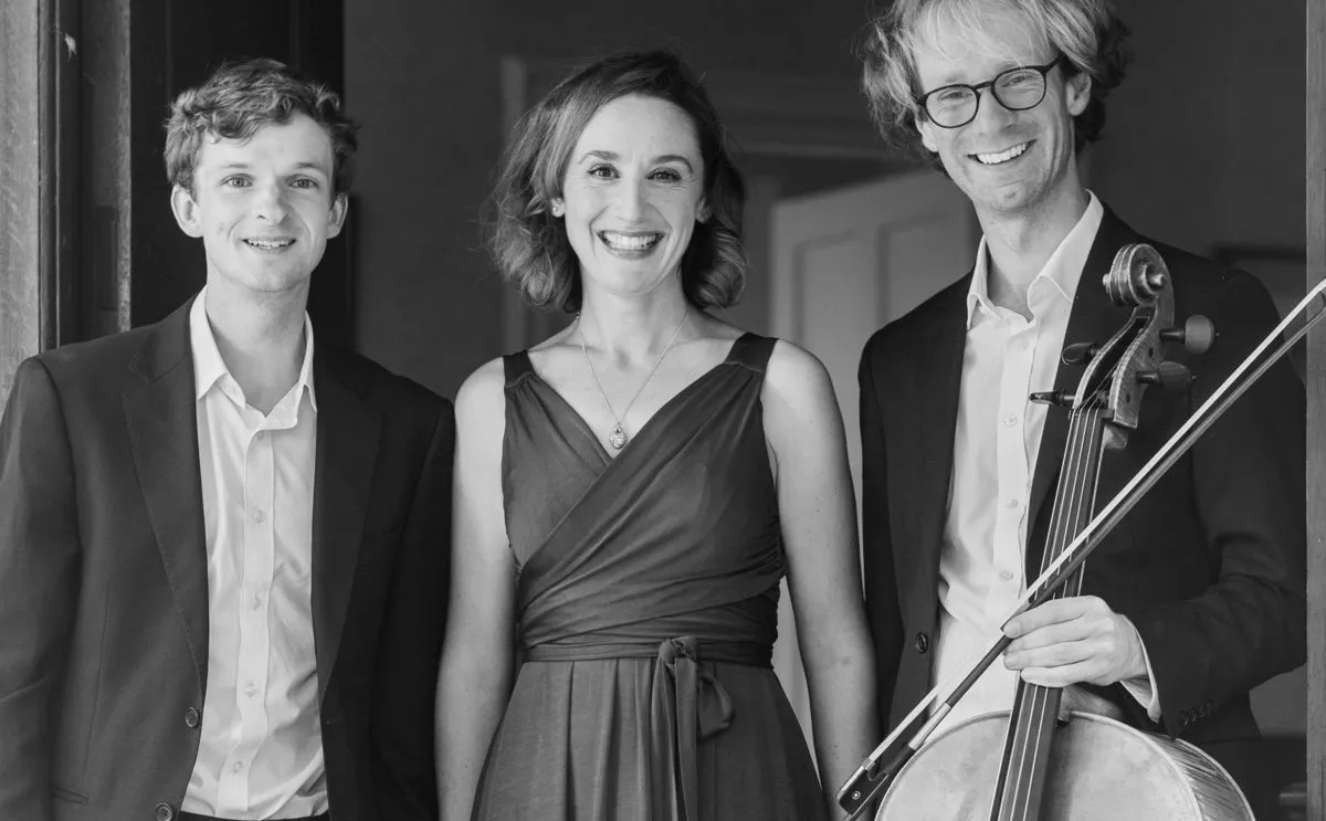 Tom Jesty, Natalie Montakhab and Erlend Vestby with his cello, standing in a doorway